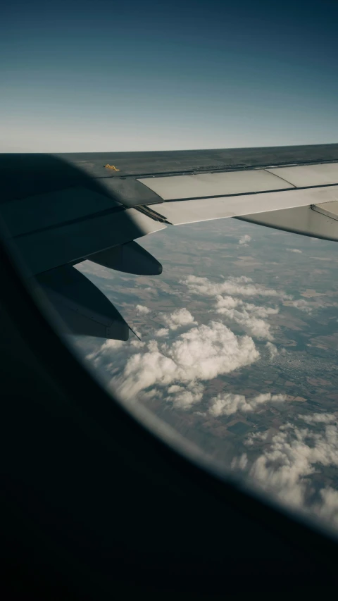 a view of clouds and a airplane wing