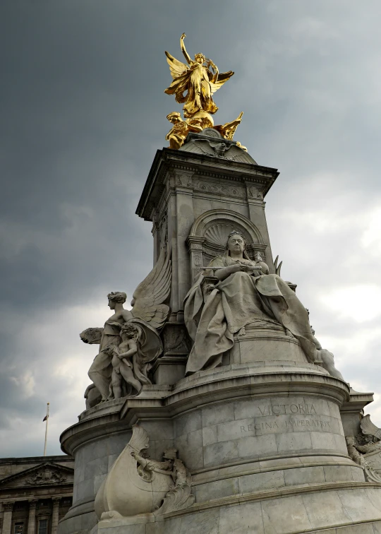 an ornate monument is shown with statues around it