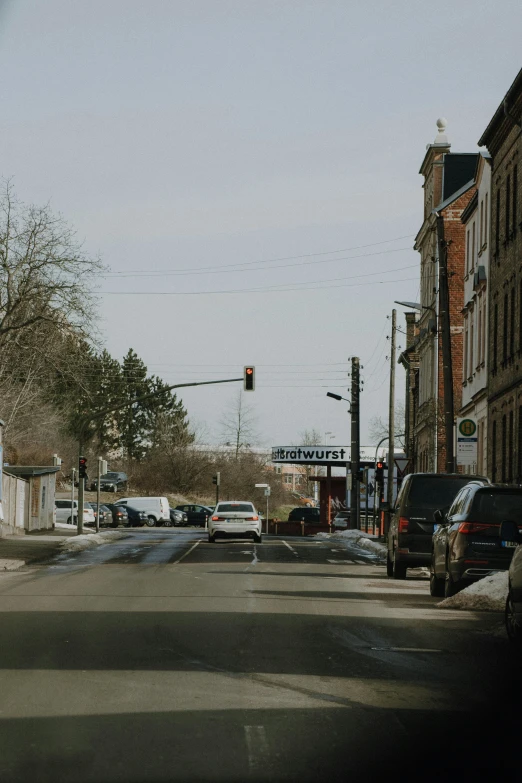 the car is traveling down the street on its own