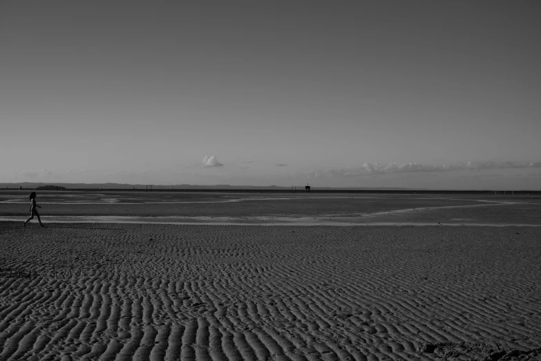 a man that is standing on the sand