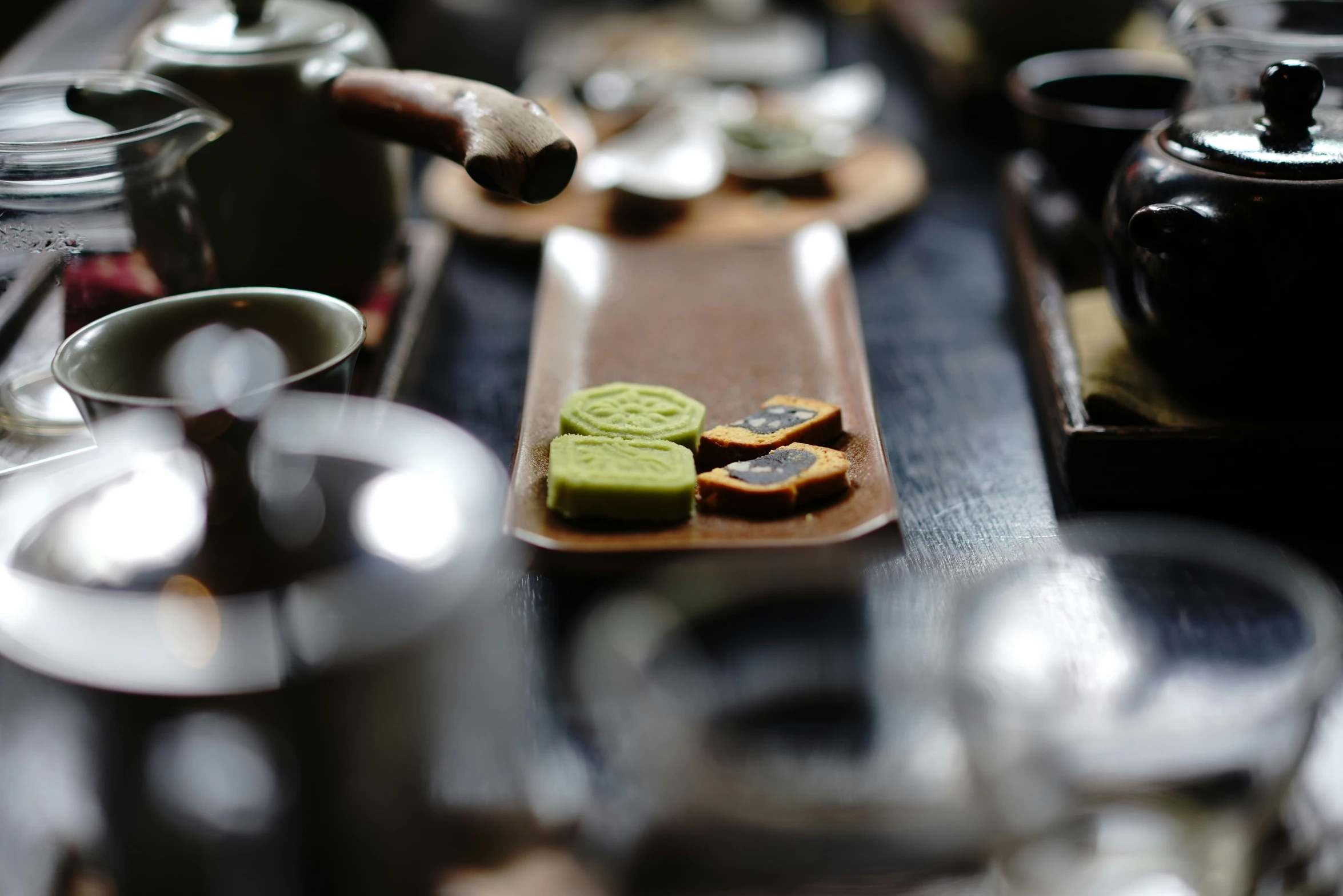 various foods and tea pots on a table