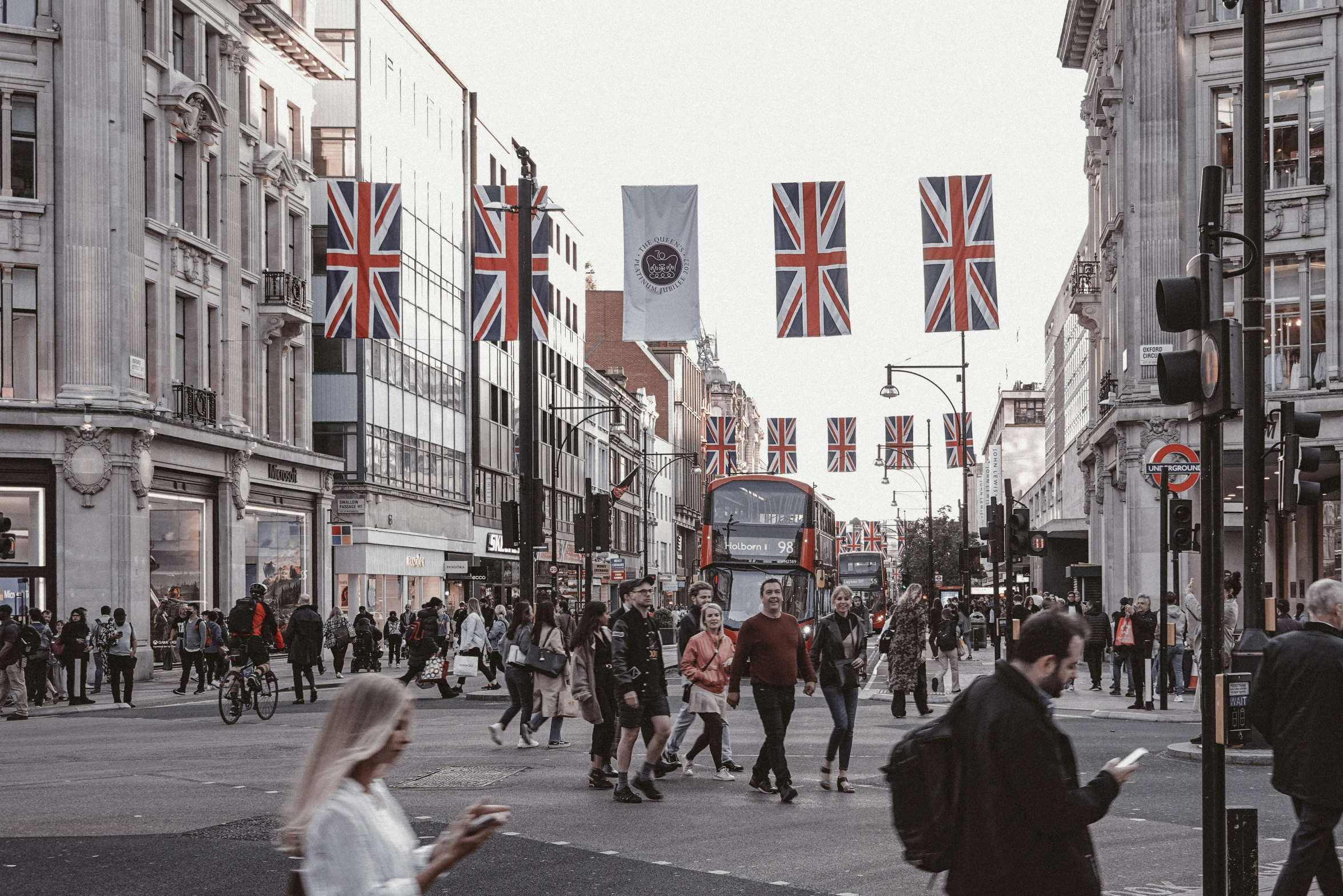 the people are walking through the crowded city