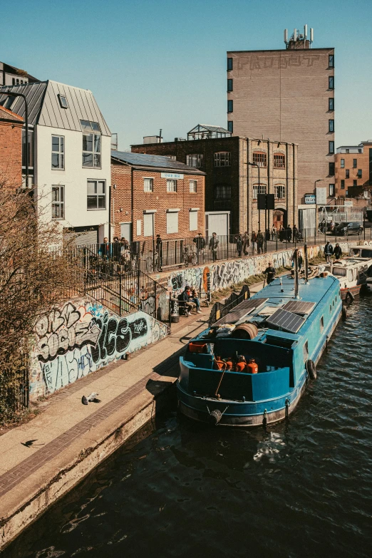 two boats that are in the water near buildings