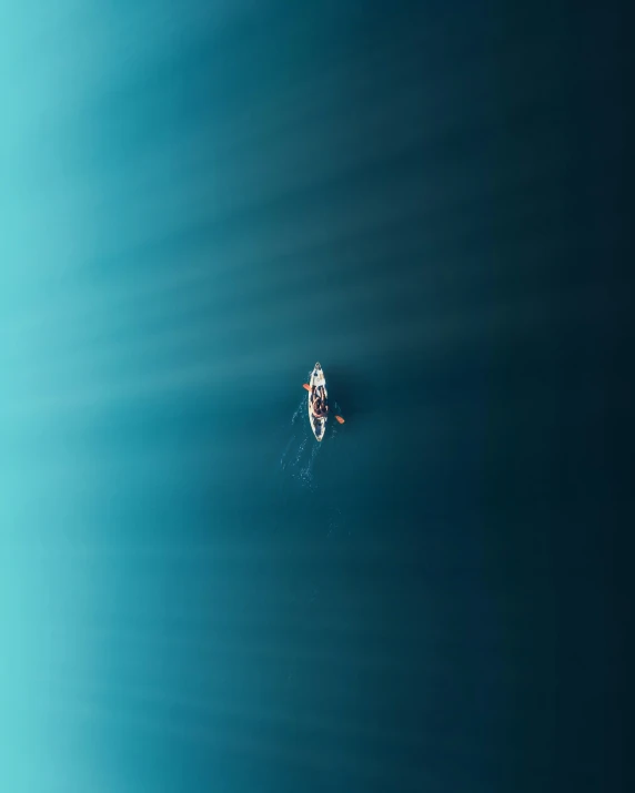 two people in a boat on a calm ocean