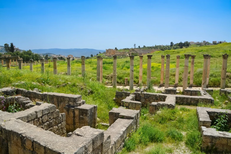 an old cemetery with several columns that are sitting in the grass