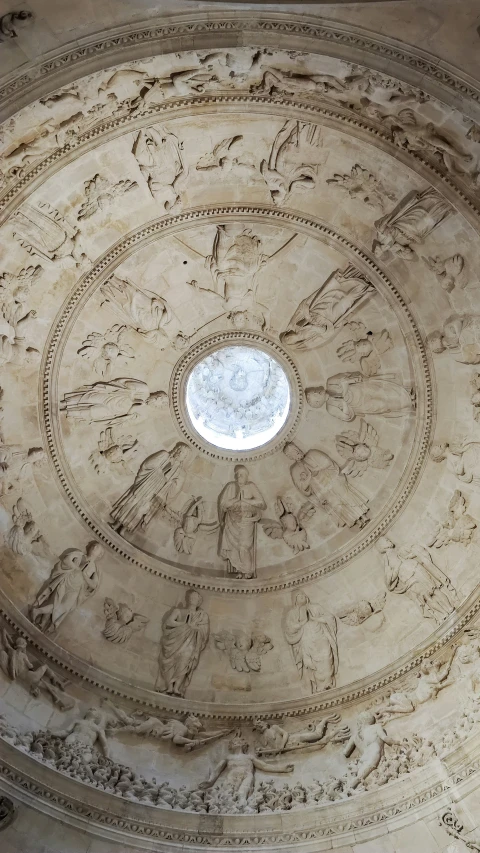 a circular painted ceiling with intricate carving work