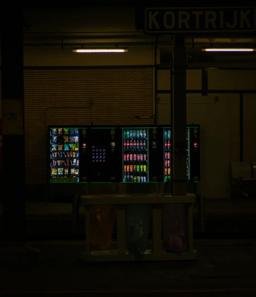 an advertising unit outside of a building in the dark