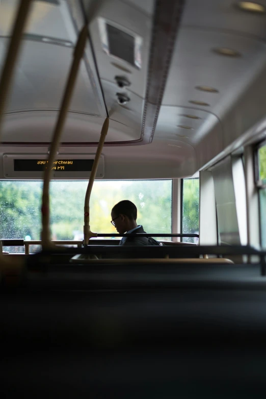 person looking out windows on public transportation