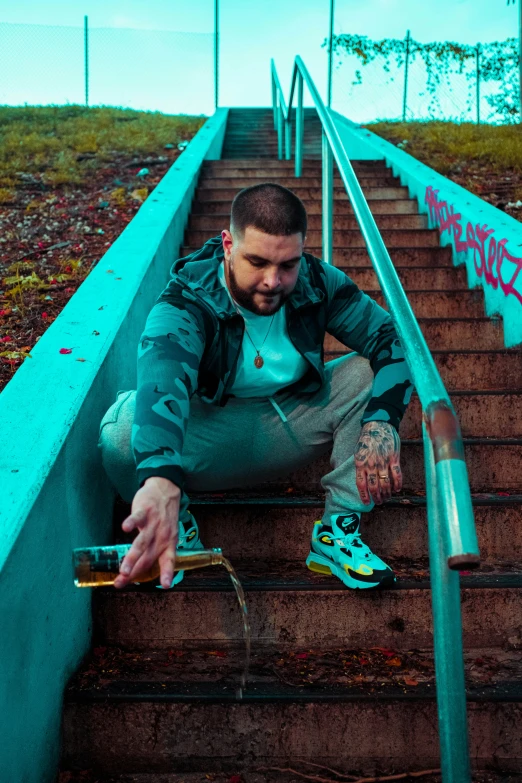 the man is sitting down on the stairs near his shoes