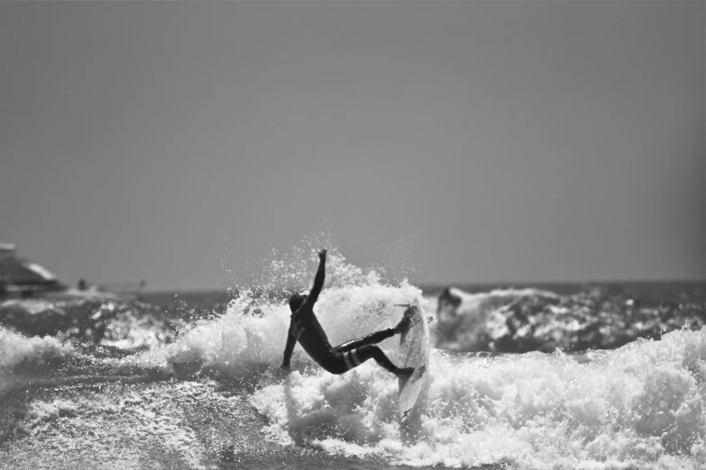 black and white pograph of surfer catching the waves