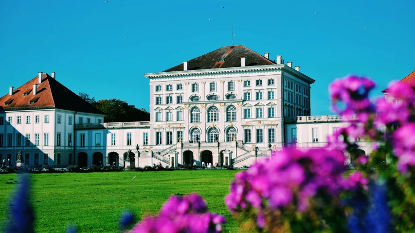 the large building is white and has red roof