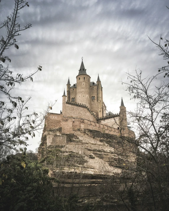 a castle with lots of tall towers in the forest