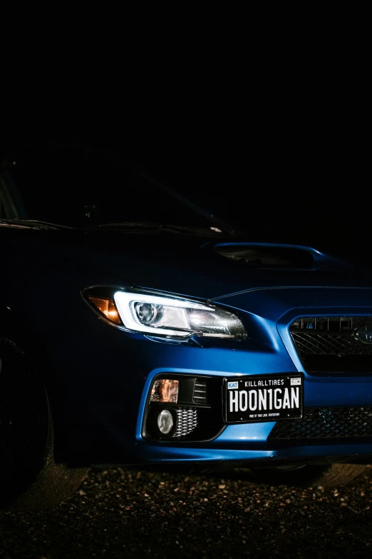 a car with a license plate and a dark background