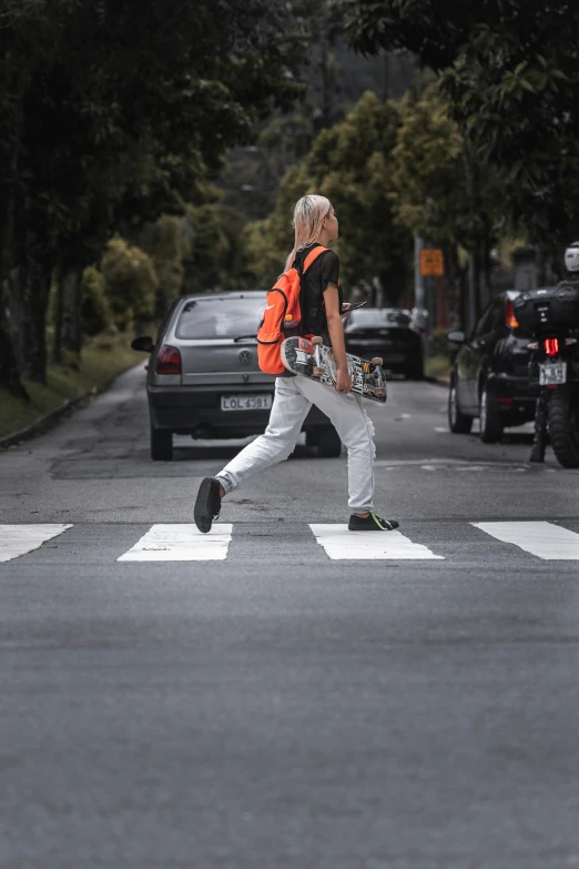 a person wearing a neon vest crossing a crosswalk