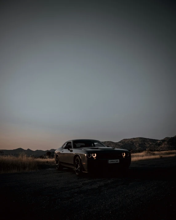 a black sports car sitting on top of a road