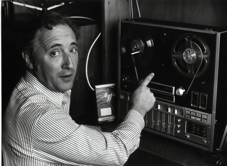 a black and white po of a man holding an radio