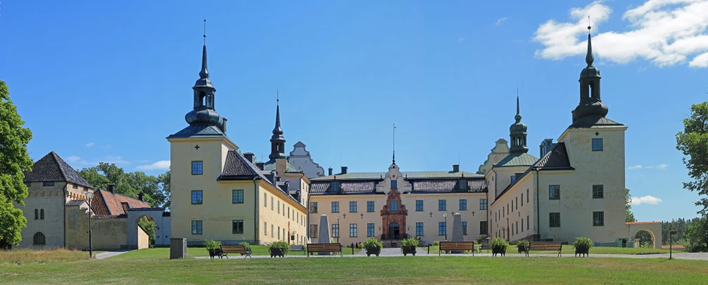 a large castle with three towers sitting in front of it