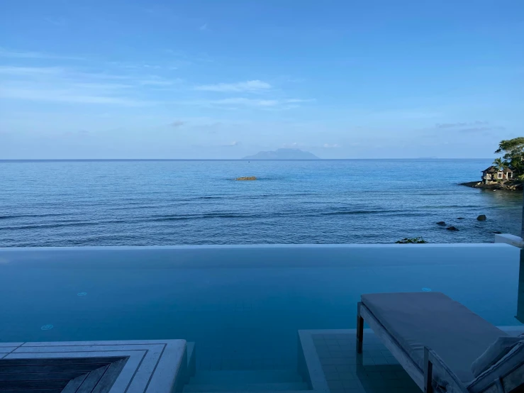 a resort's pool overlooking the ocean is pictured