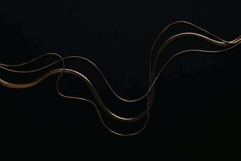 some gold wavy string with a black background