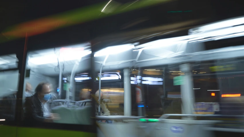 passengers ride on the bus at night, blurred, and abstract