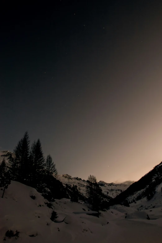 a person on snow skis goes down a snowy hill