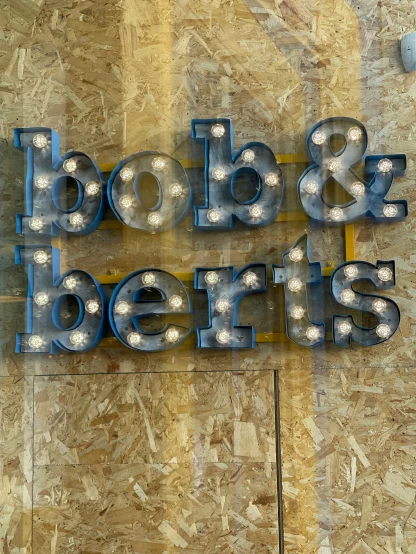 some lights are attached to the letters boo and beers
