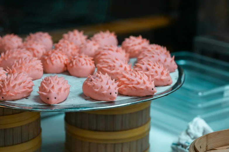 some pink cupcakes that are on a tray