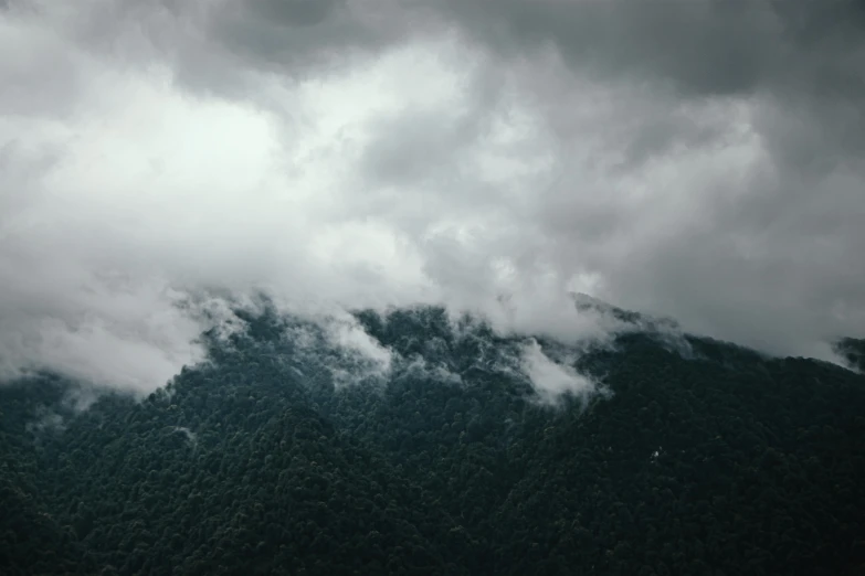 a view of clouds from the top of a mountain