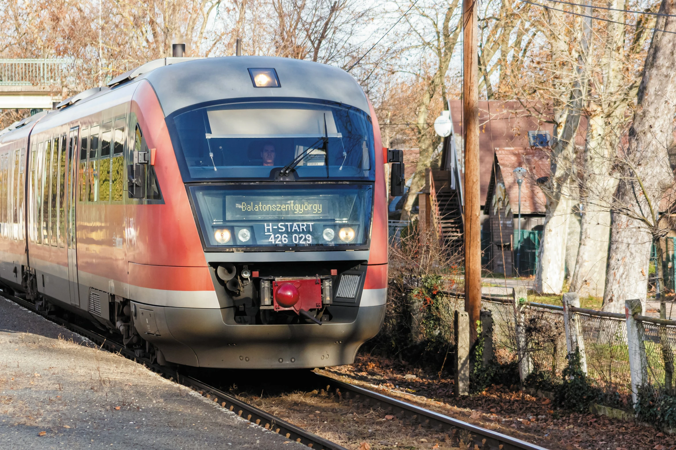 a red and black train stopped at the station