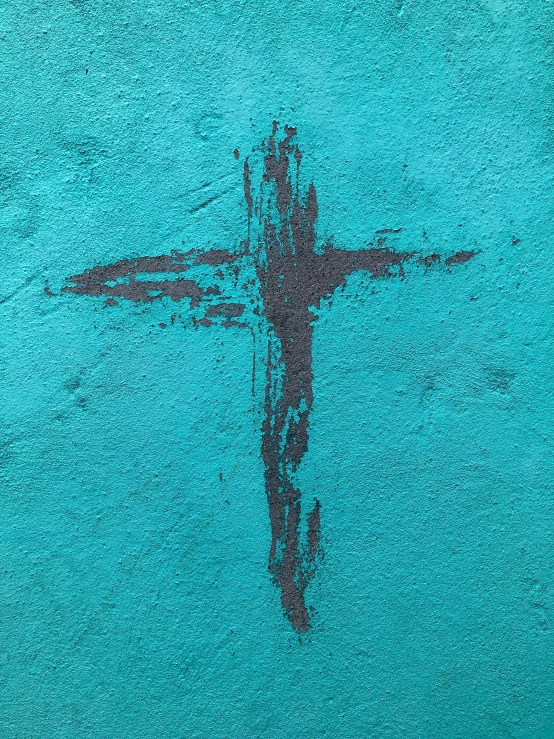 cross painted on the side of a building