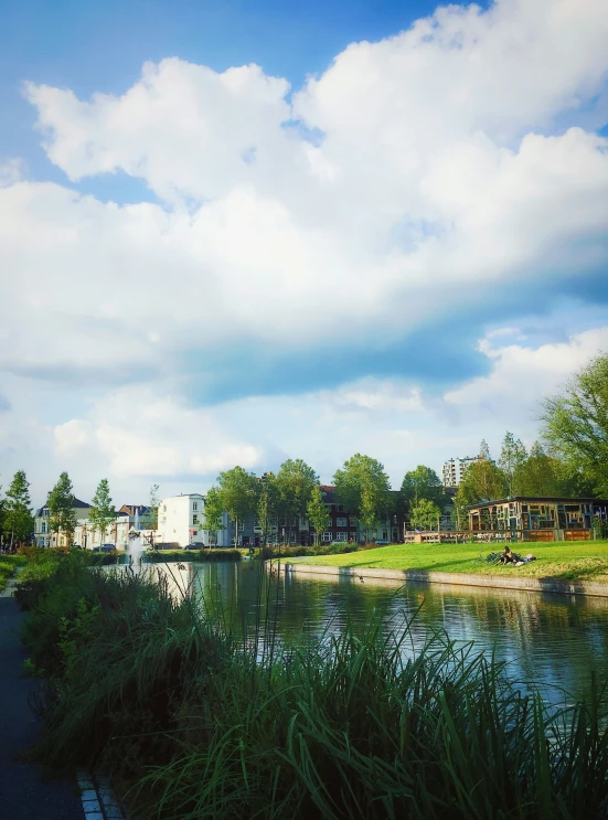 people walking by a path beside the water