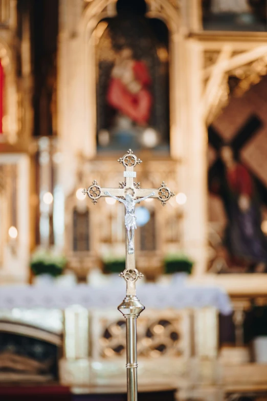 a small glass cross in front of a pew