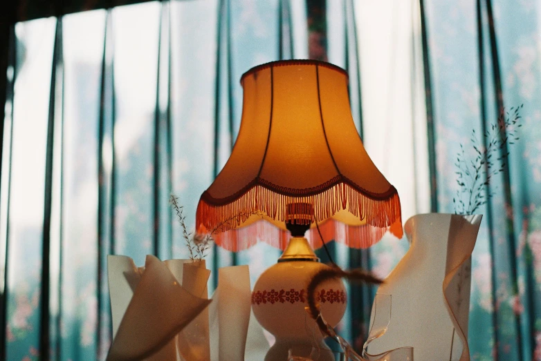 a lamp next to decorative white bags in a room