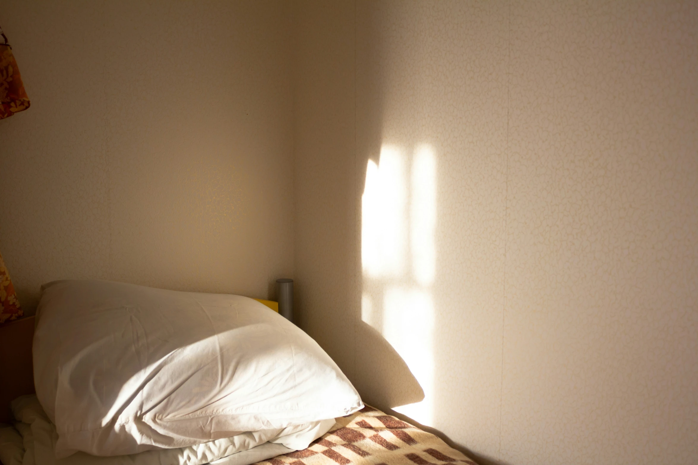 a bed with a pillow and blankets on top