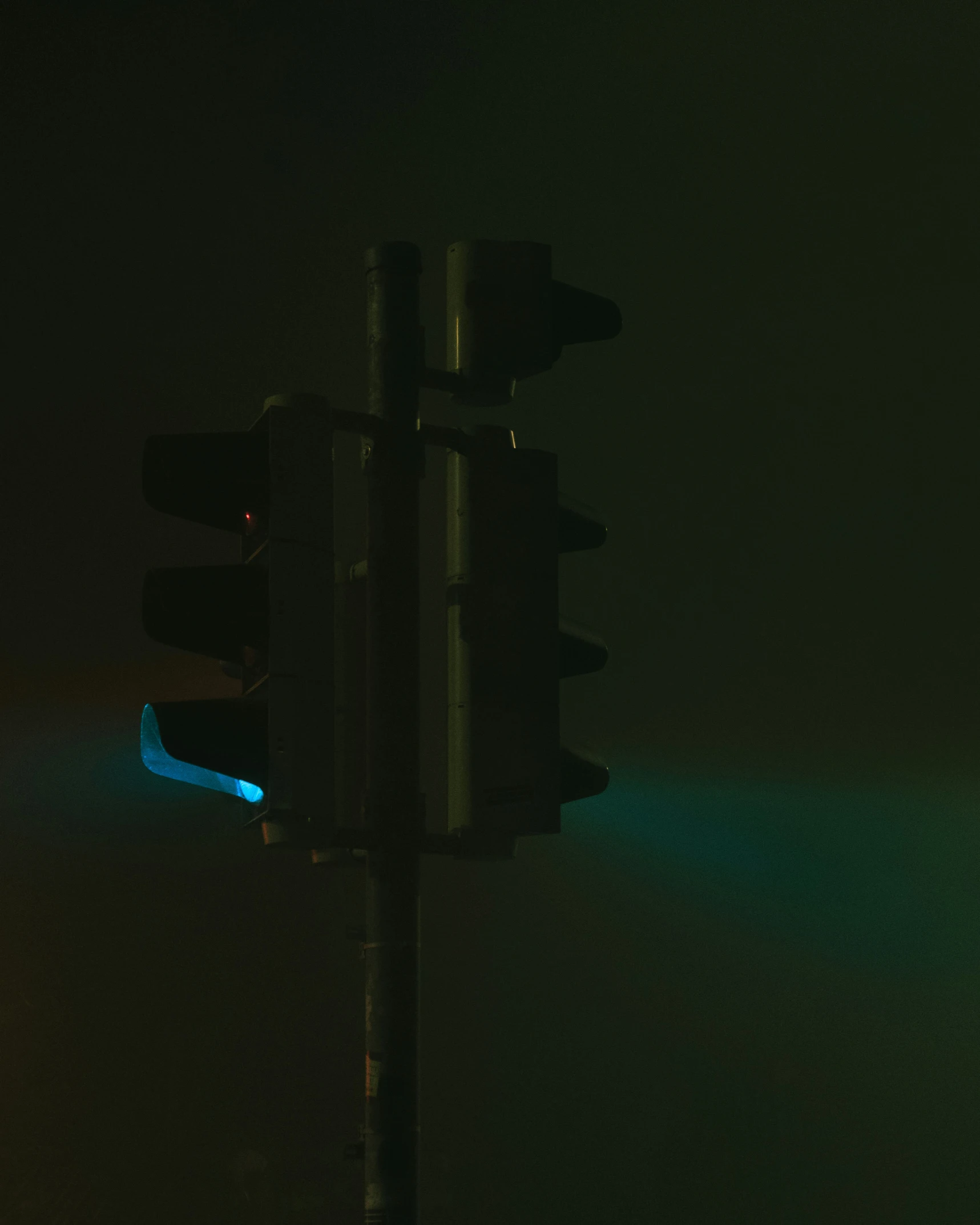 there is a green light behind a street sign