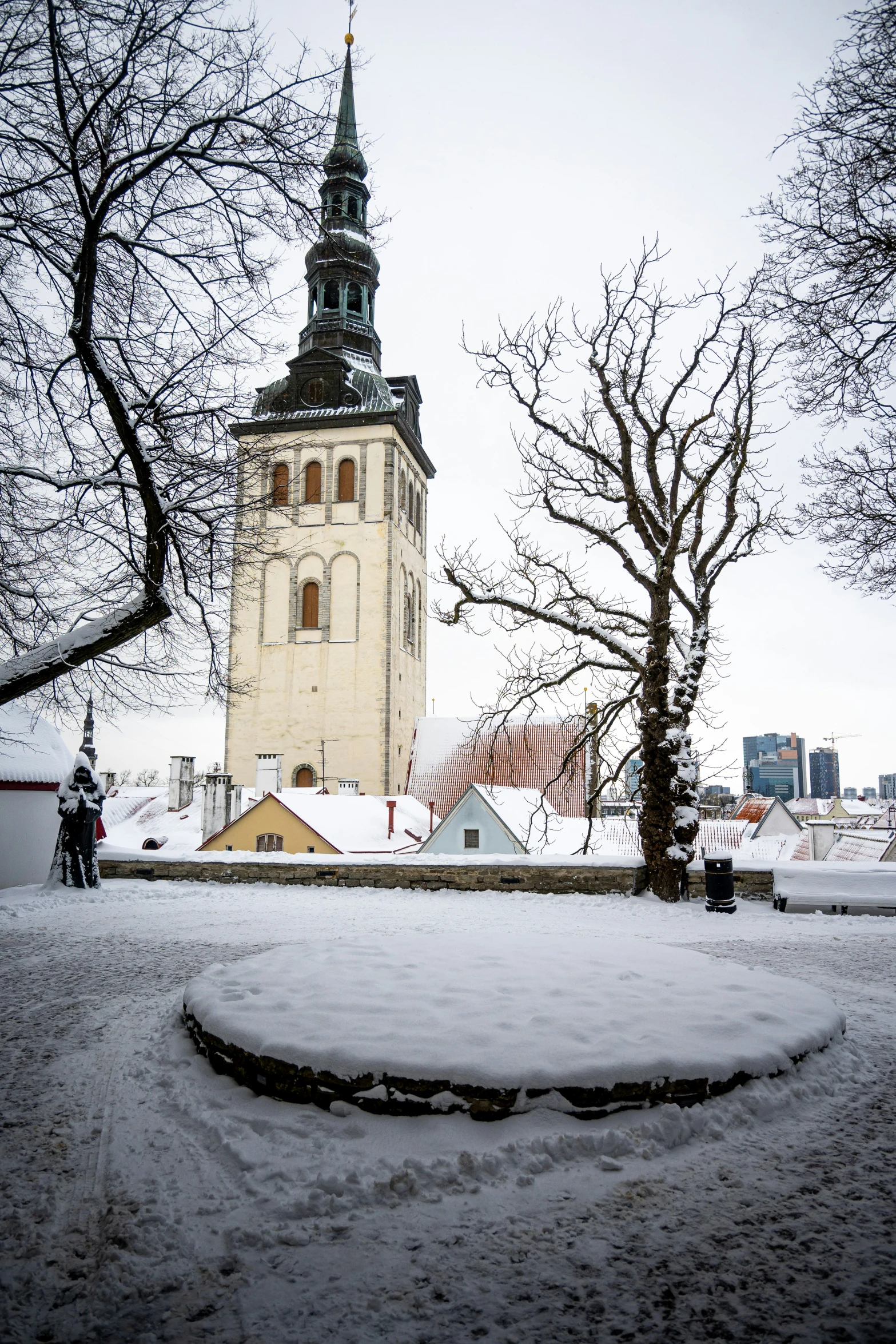 a large building sitting in the middle of a field covered in snow