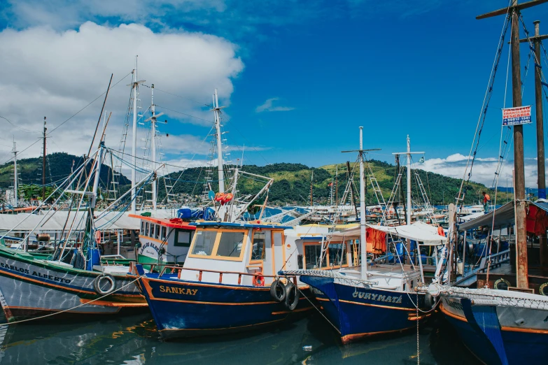 a group of boats sitting in a harbor next to each other