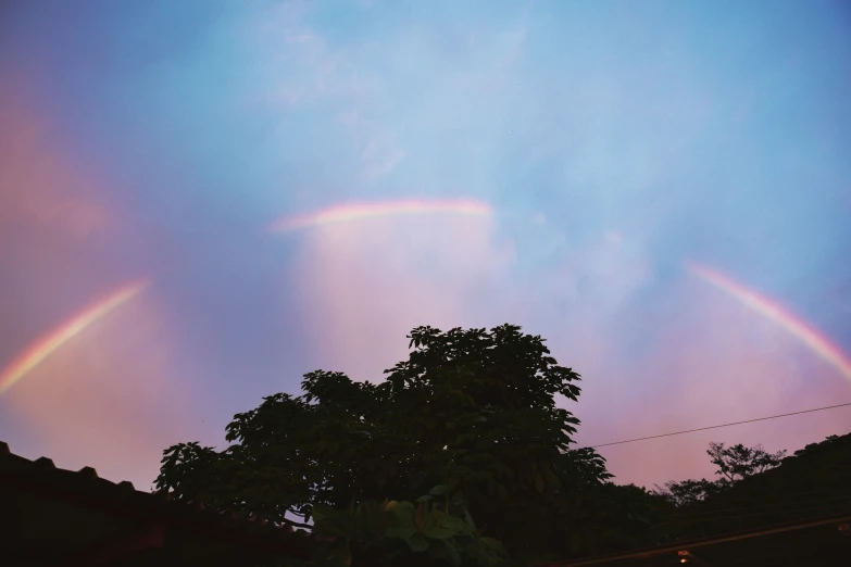 a rainbow in the sky and two rainbows are seen