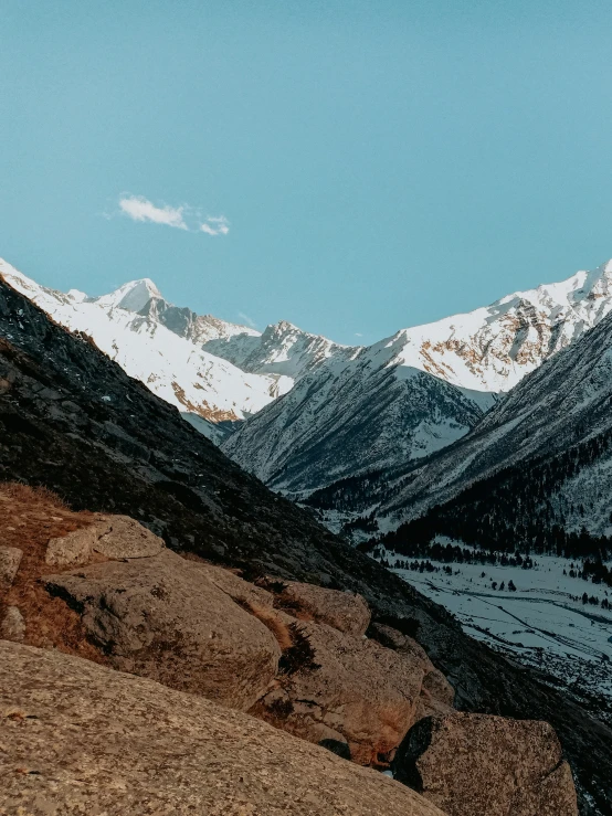 a snow covered mountain range with a blue sky