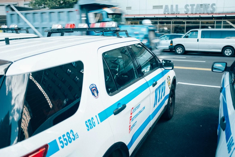 a view from behind two police cars during the day