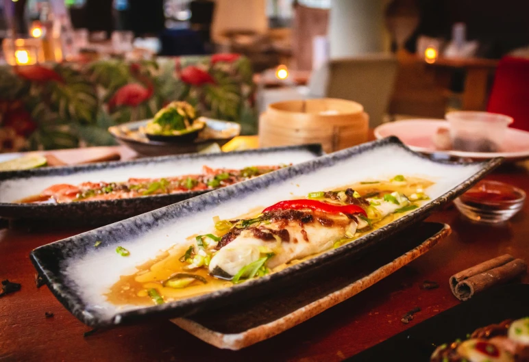 three rectangular plates containing food in a restaurant