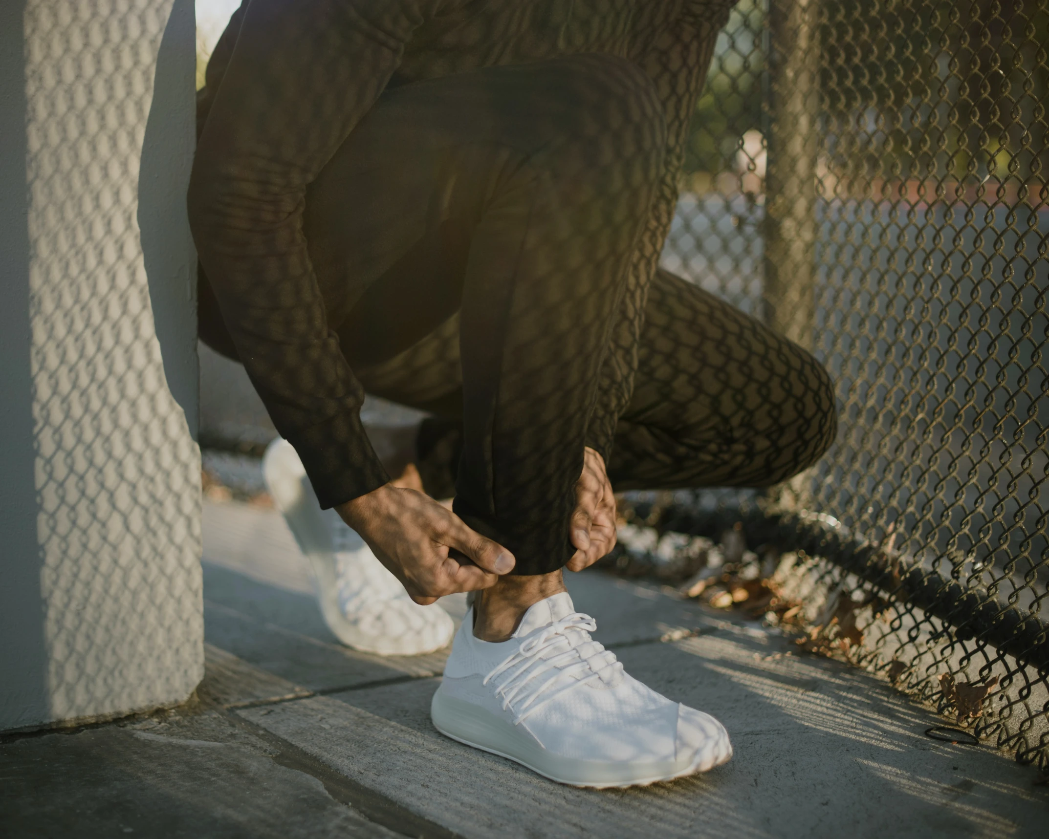 the man is stretching his foot on the ground