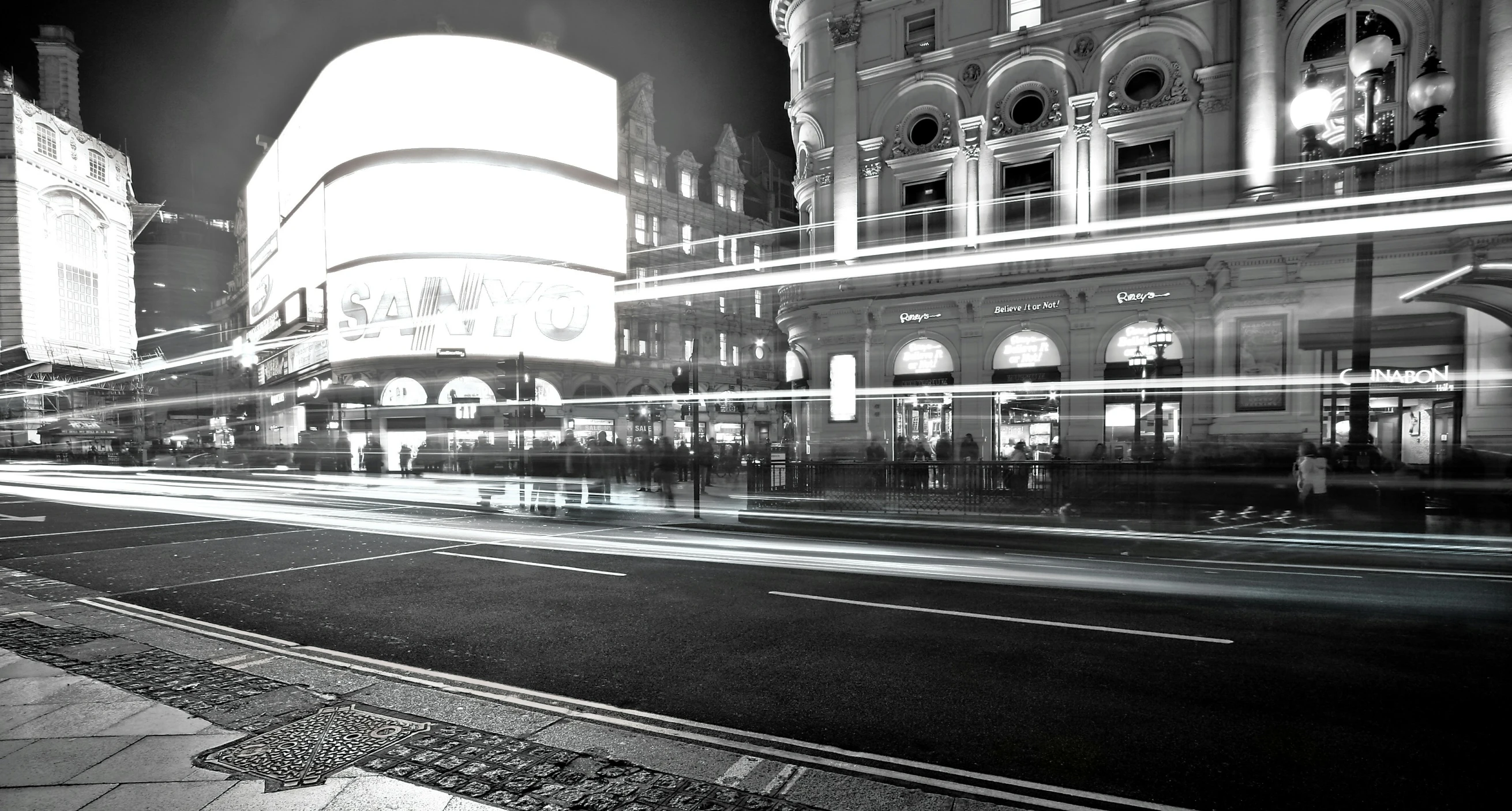 a black and white po of the night lights on the city street