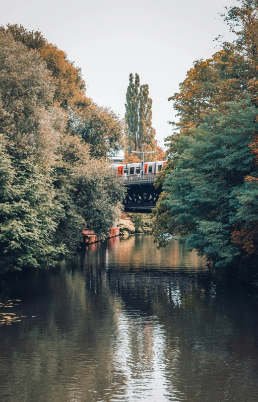 a train on a track going over a bridge over a river