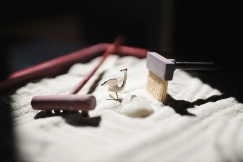 some pink brushes sit on top of a towel