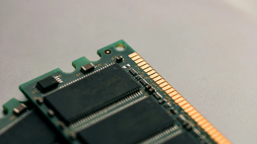 a green and gold computer ram sitting on top of a gray counter