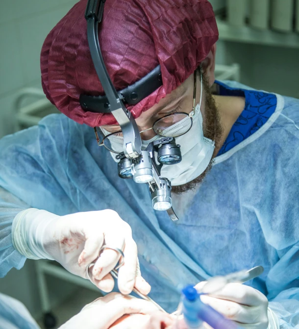 a man in blue is performing  in the hospital