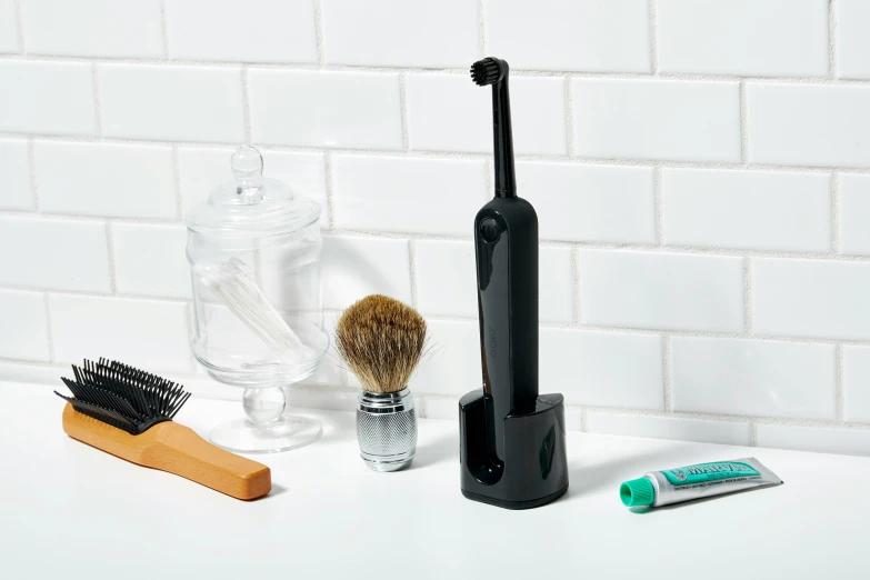 two brushes and an assortment of other hygiene items on counter