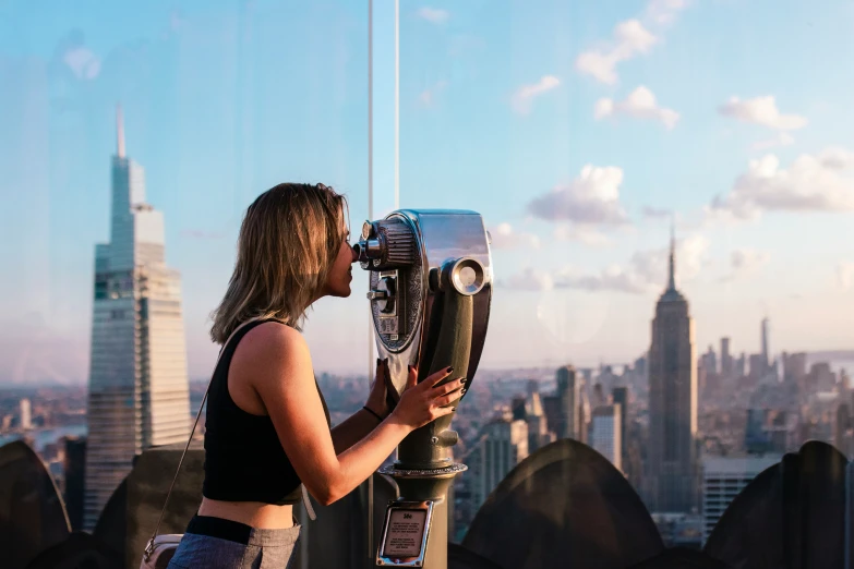 a woman that is looking at a binoculars