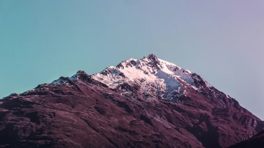 snow covered mountain and blue sky on a sunny day